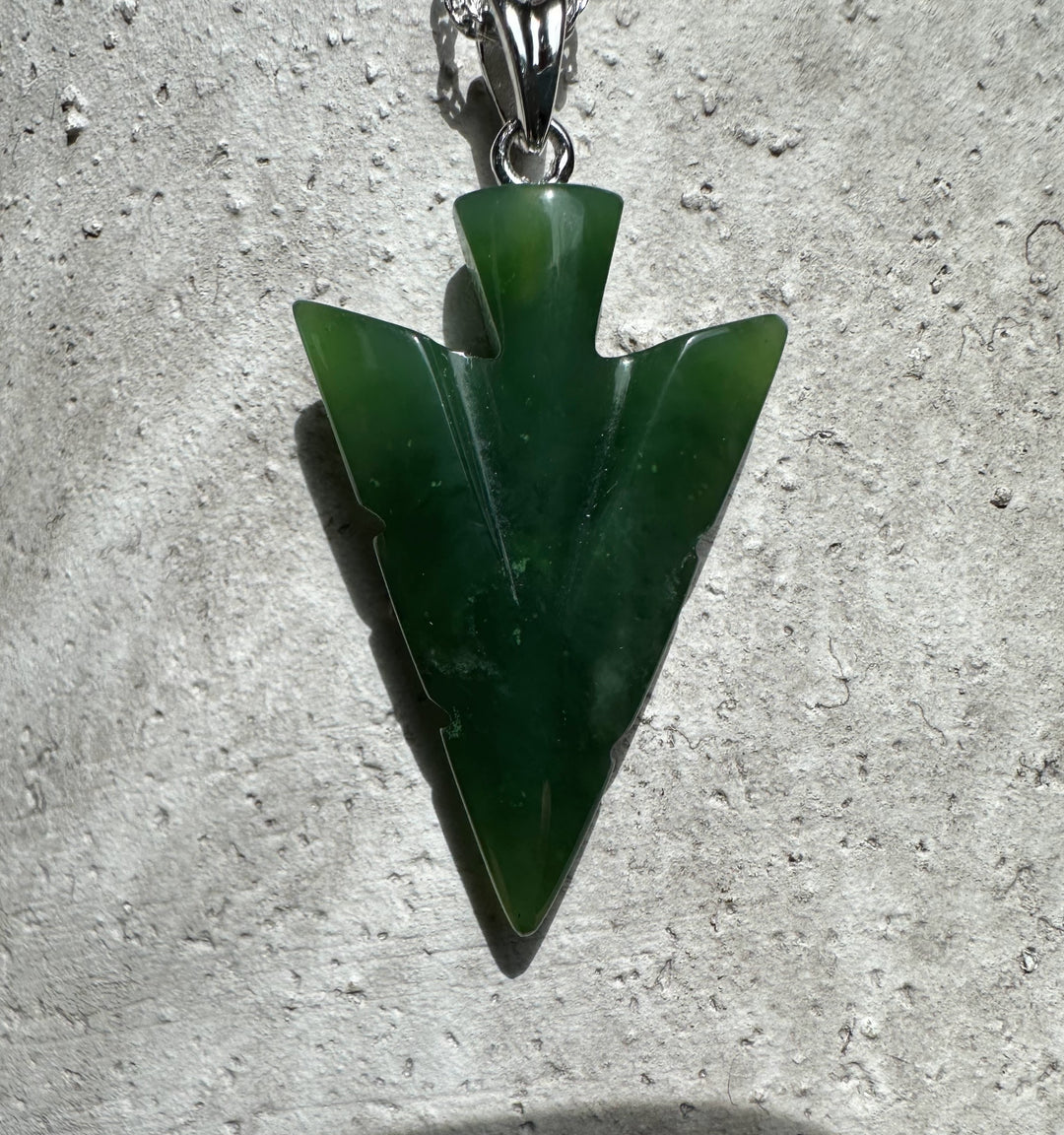 Canadian Jade Arrow Pendant in deep green with a silver bail on a necklace