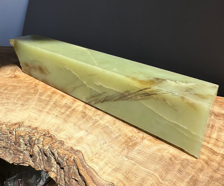 Green white slab on a wooden surface with a dark background