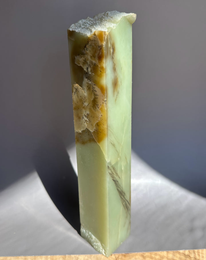 Jade green and brown and white on a gray background