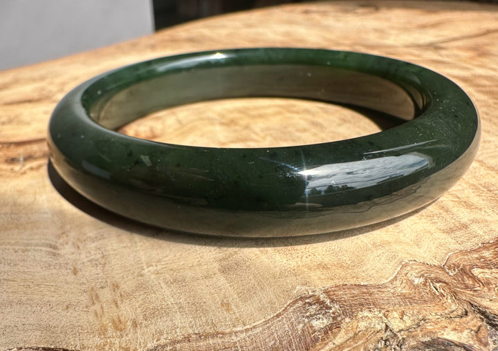 Green bangle on a wooden surface