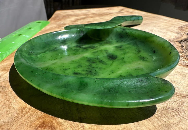 Green jade dish on a wooden surface