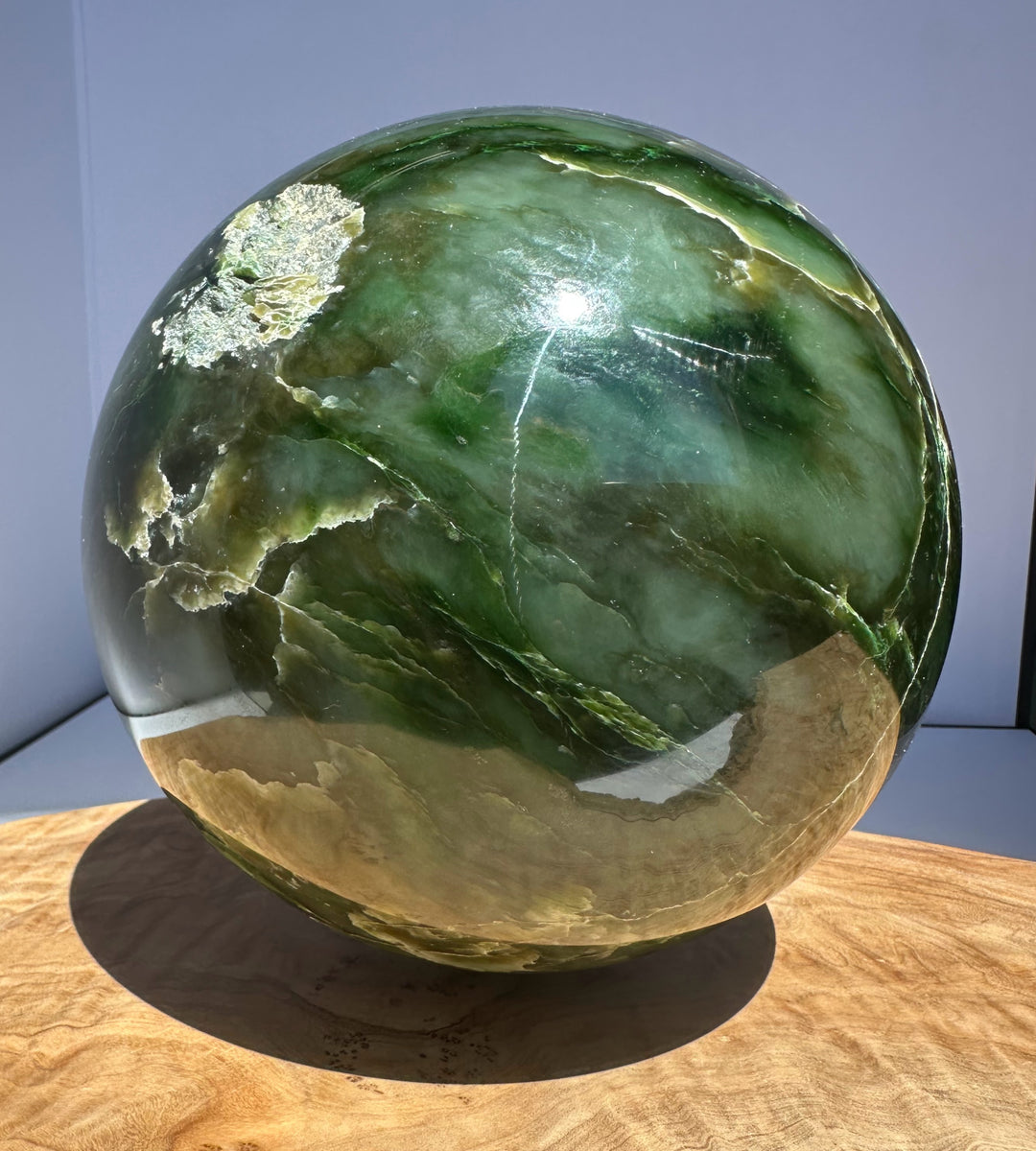 Top front view of a 6 inch Polar Jade Sphere featuring green swirls and reflective highlights