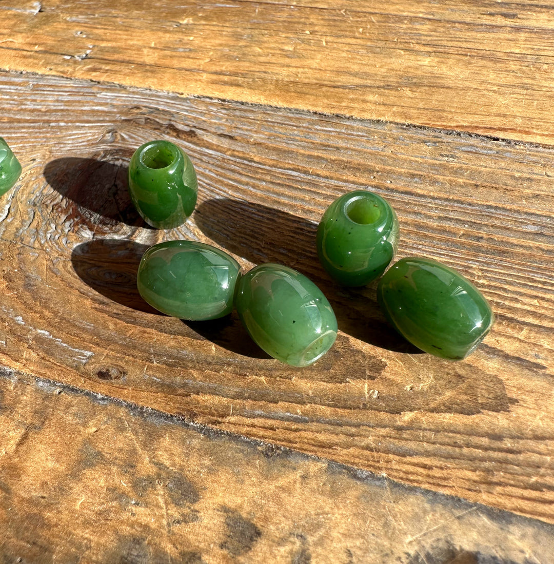 Group of green 12x15mm beads with a copper chain on a wooden surface