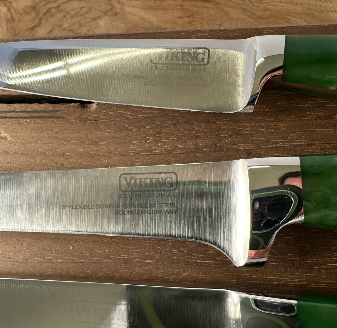 Two Viking brand knives on a wooden surface