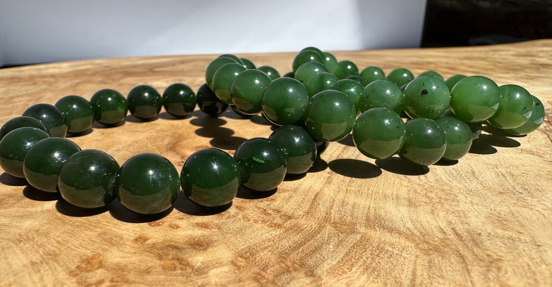 Green beaded bracelet on a wooden surface