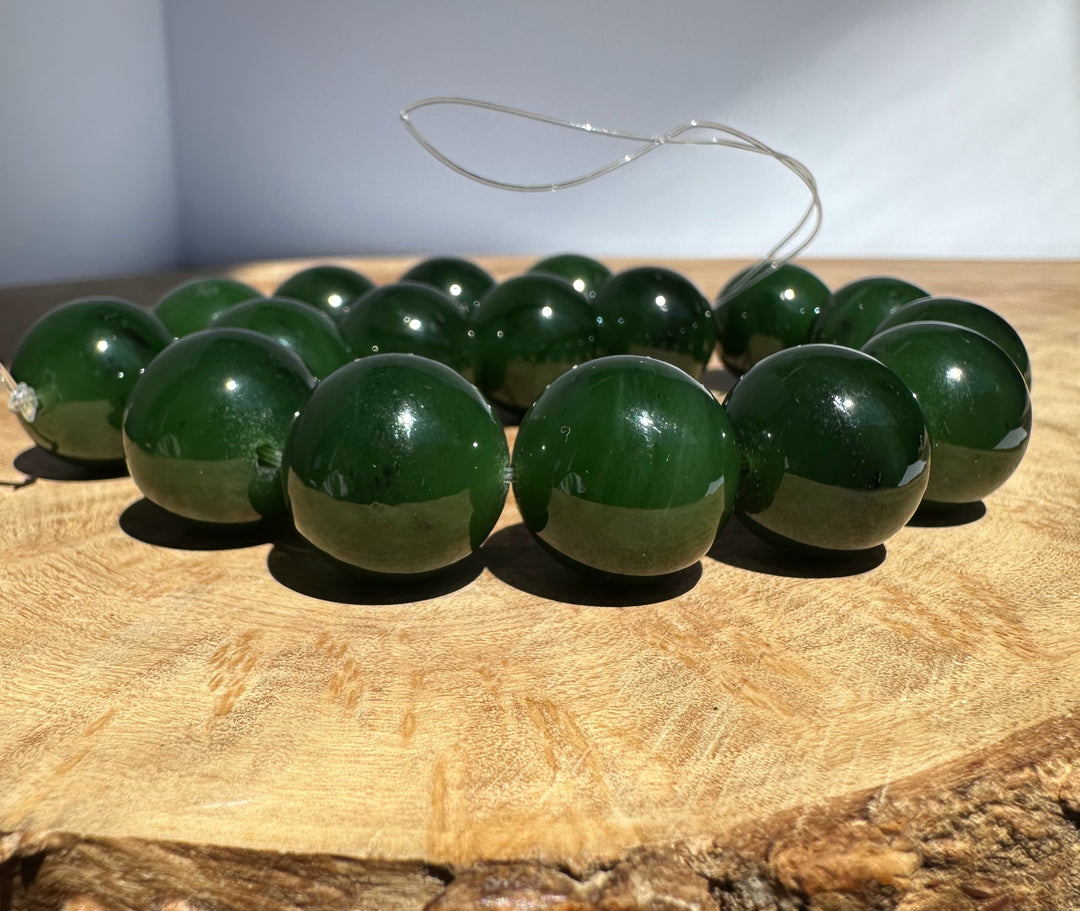 Green jade beads on a wooden surface