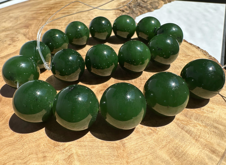 Green beads unstrung on a wooden surface
