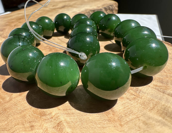 Green beads on a string on a wooden surface