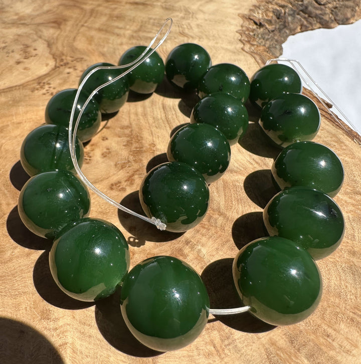 Green beads on a wooden surface