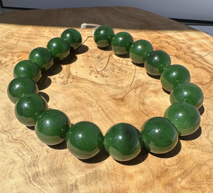 Green jade beaded bracelet on a wooden surface