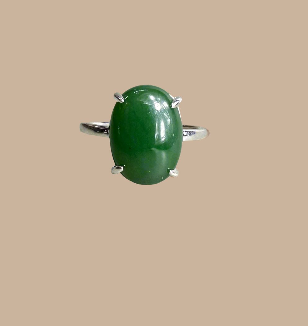 Canadian jade and silver ring featuring a green oval jade cabochon set in a silver band