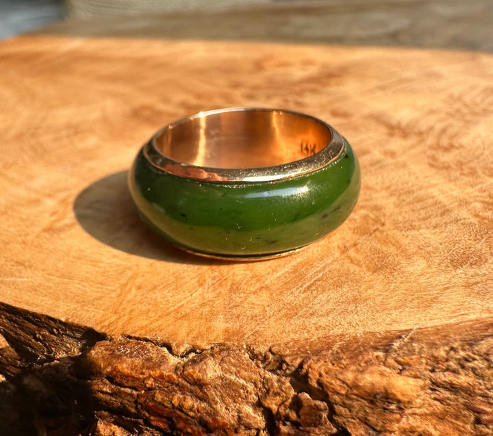 Side view of a vintage Canadian 14k gold ring with a green enamel band size 8