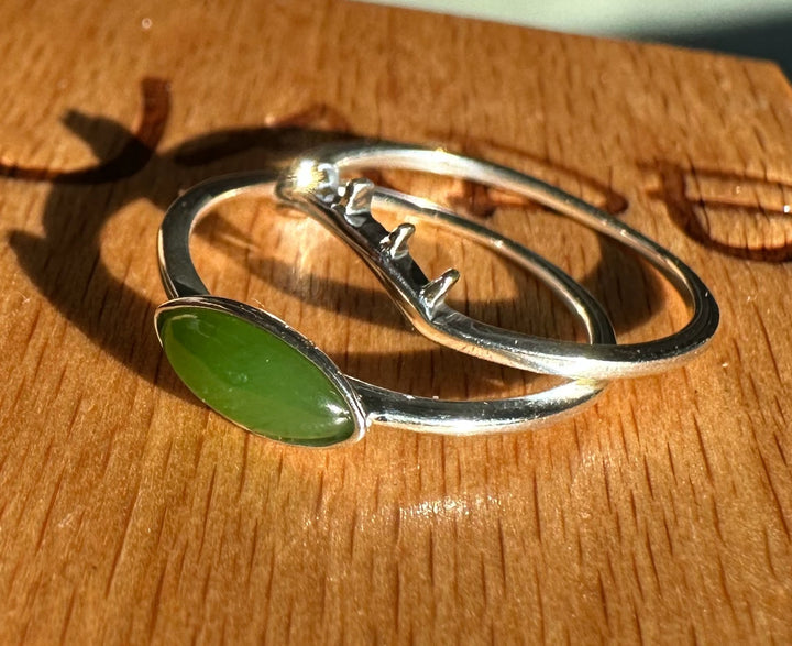 Canadian Jade and Silver Eye Ring with two curved silver bands and a green jade cabochon at the front