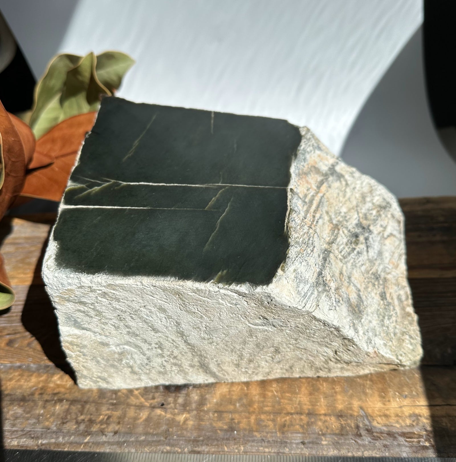 Wyoming Jade piece showing two dark green rectangular slabs on a light gray rock.