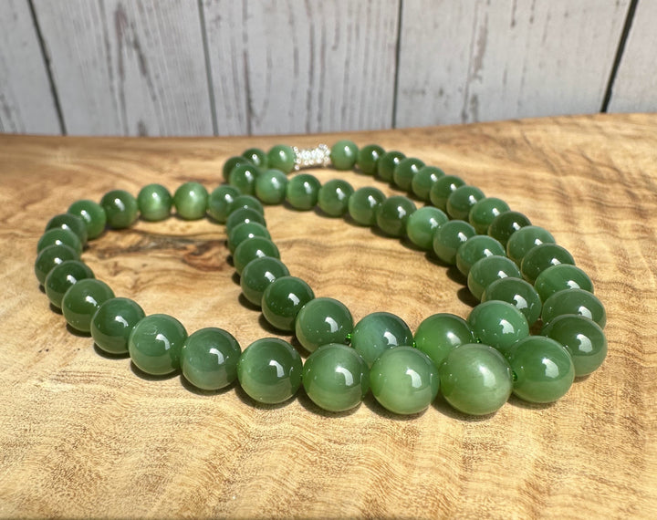 8mm chatoyant Siberian beads arranged on a wooden surface with a clasp visible