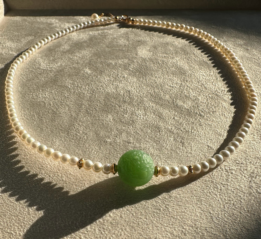Siberian and Pearl Necklace with white pearls and a large green carved centerpiece bead with gold accents