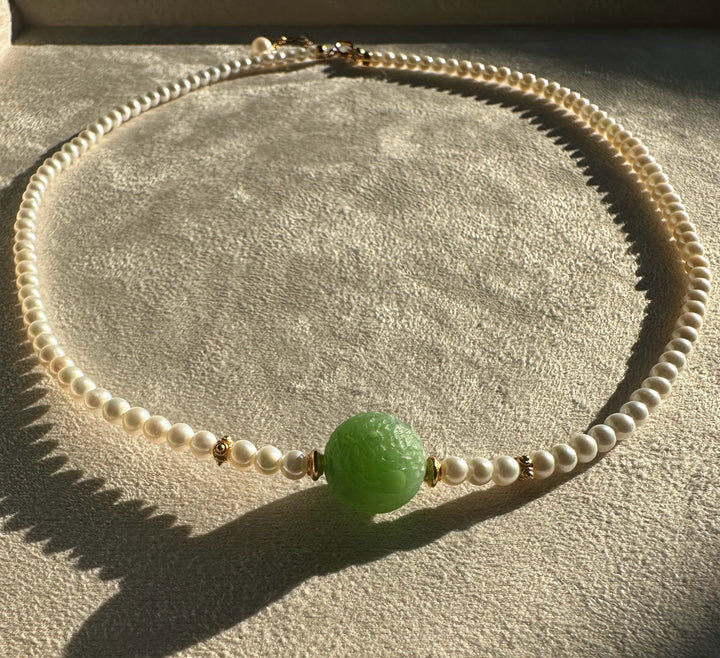 Siberian and Pearl Necklace with white pearls and a large green carved centerpiece bead with gold accents