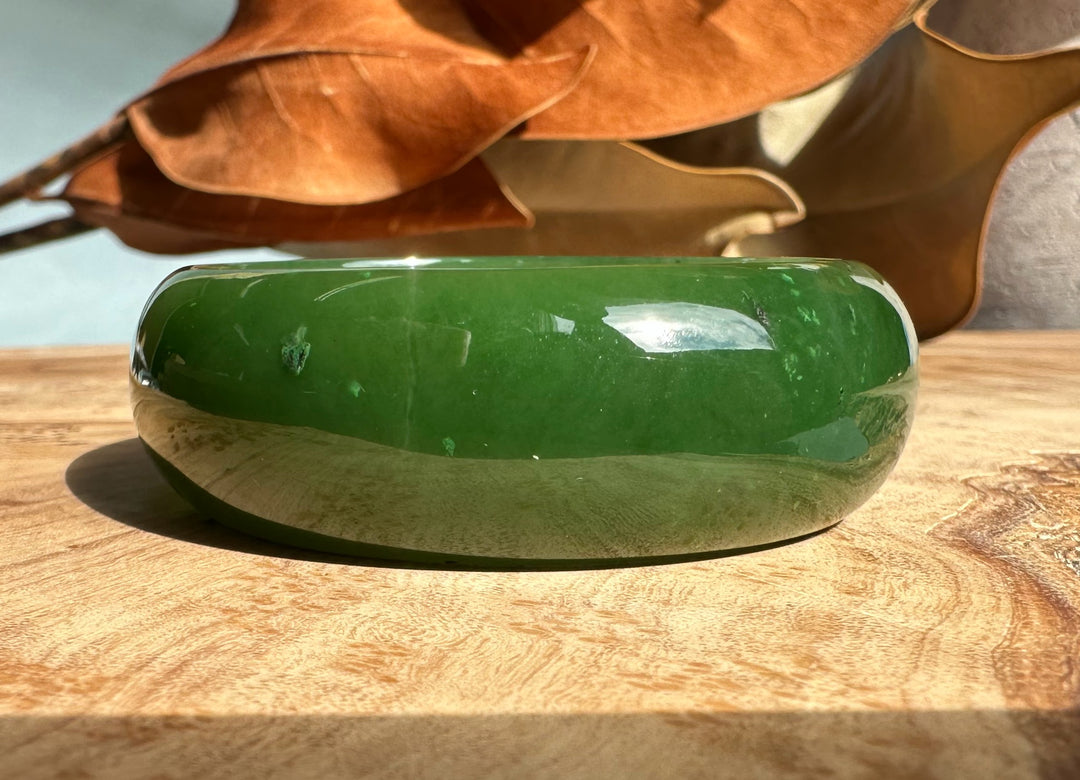Side view of A+ Canadian Jade Oval Bangle 52.5mm deep green jade showing rounded polished edge
