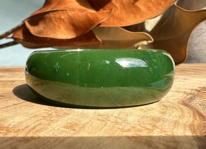 Side view of A+ Canadian Jade Oval Bangle 52.5mm deep green jade showing rounded polished edge