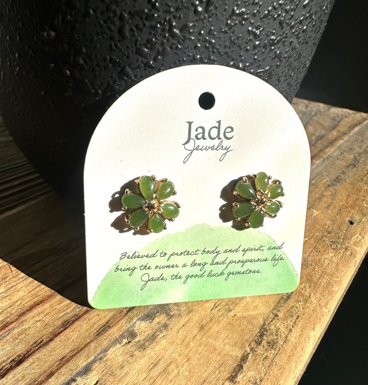 Green jade flower stud earrings on a white display card with Jade Jewelry branding