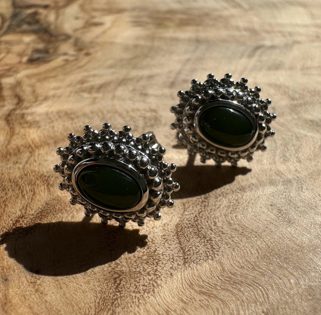 Canadian Jade and Silver Earrings featuring a dark green oval jade center surrounded by a silver beaded halo