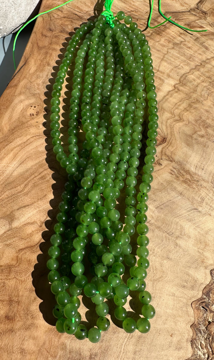Green 6mm beads on multiple 16 inch strands gathered with neon cords