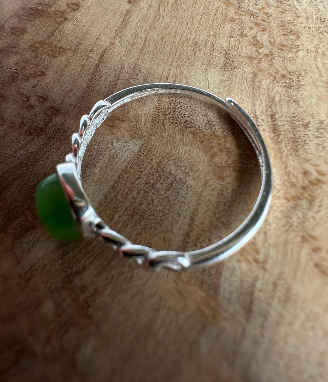 silver ring stamp on wooden base in the shadows