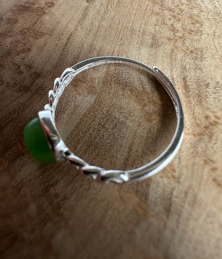 silver ring stamp on wooden base in the shadows