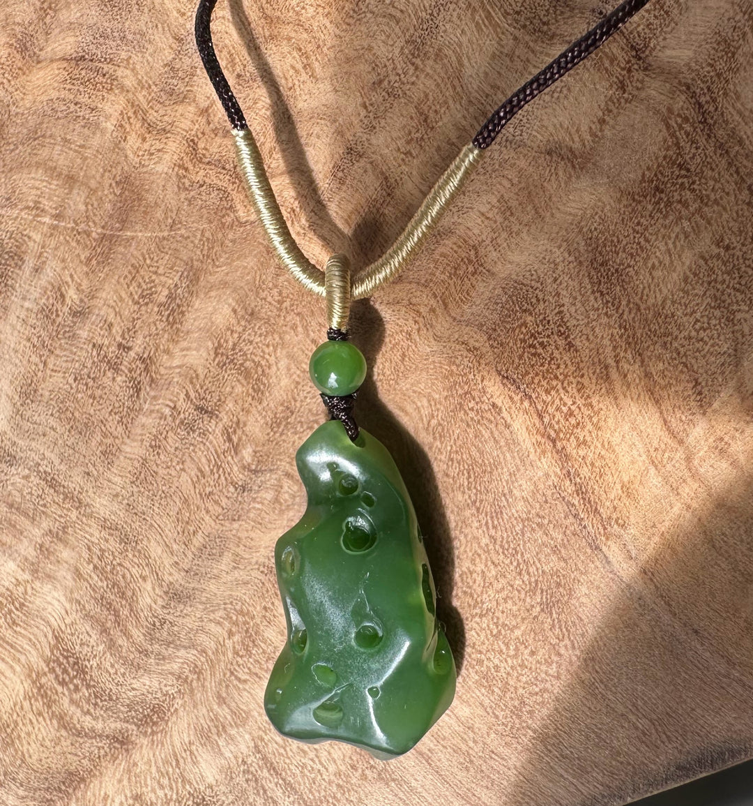 Rich green Siberian abstract jade pendant on a two tone braided cord with green bead accents