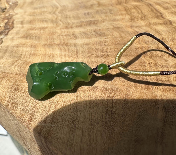 Rich green Siberian abstract pendant on black and pale gold braided cords