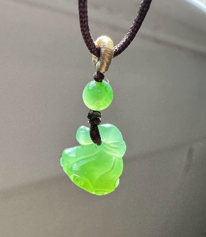 Apple Siberian Jade lotus seed pod pendant on a dark brown braided cord with a bright green bead