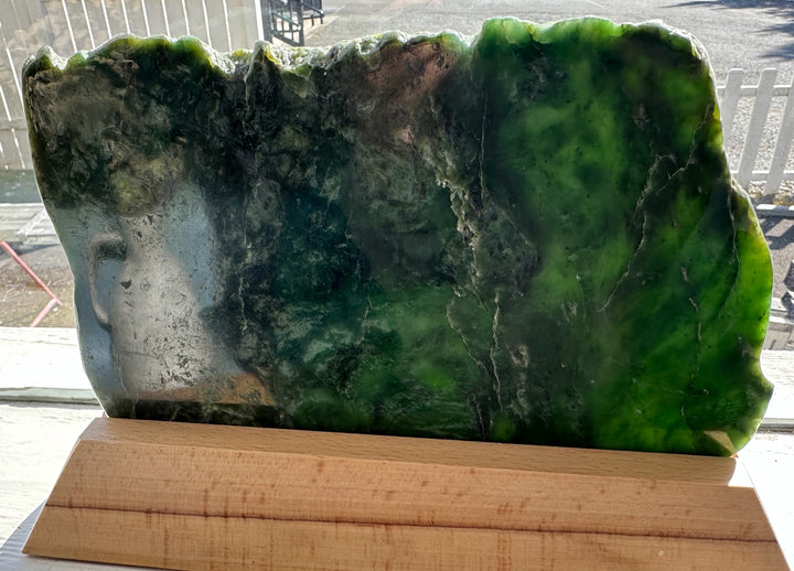 Canadian Jade Slab on base with dark green to black marbling and lighter green veins.