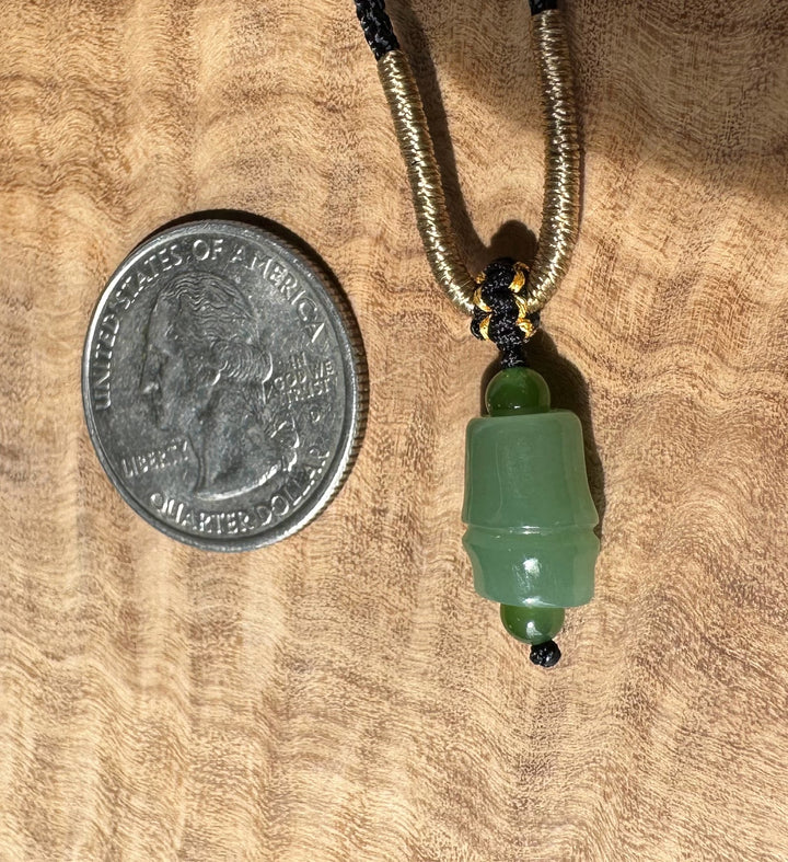 Siberian Jade Pendant 11mm with gold bronze tube beads at the top of the green jade pendant on a black cord