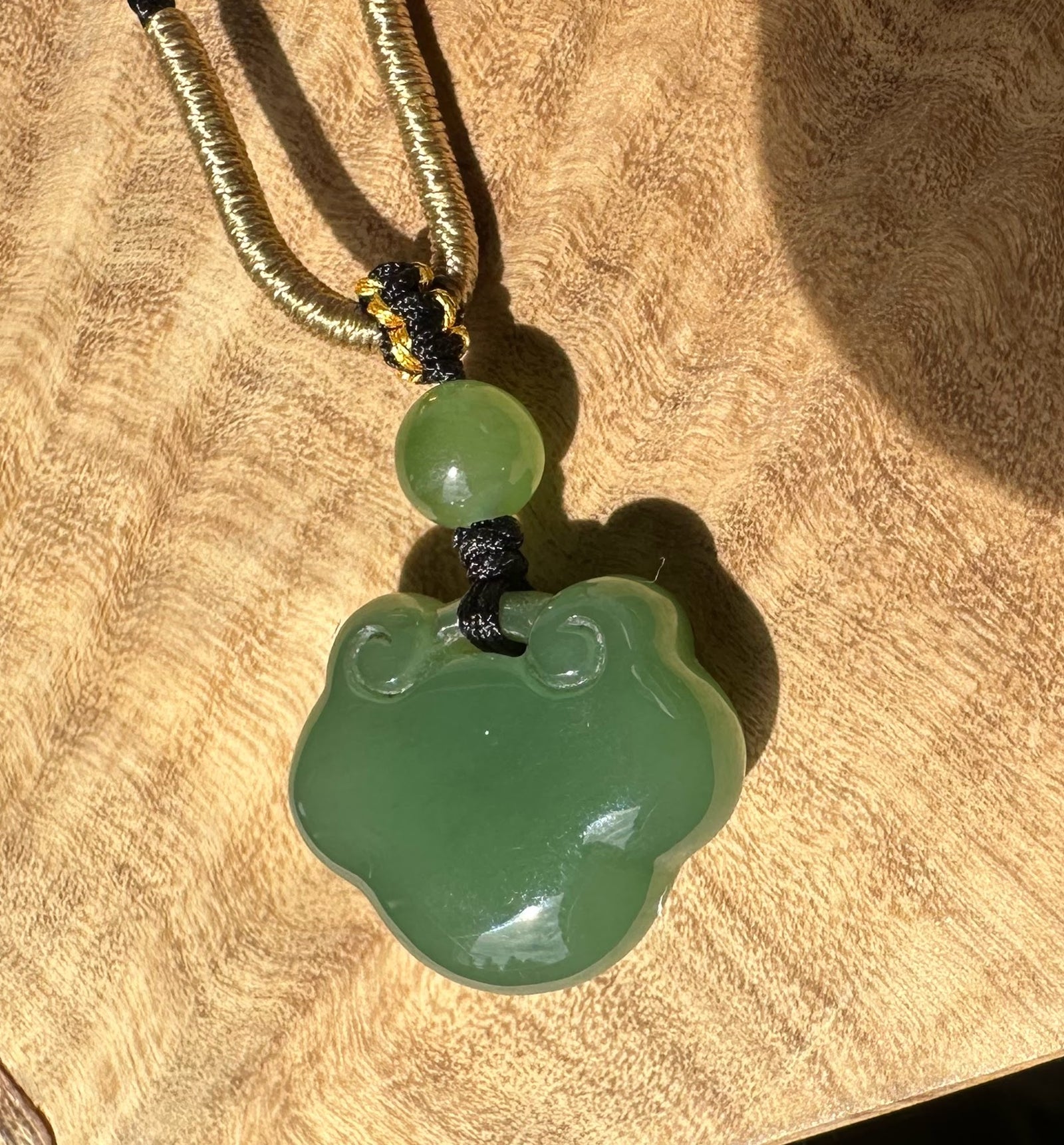 A+ Siberian Green Nephrite Jade Ruyi Pendant 19mm on a tan braided cord with black knot accent
