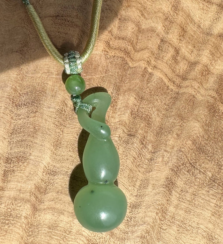 Siberian nephrite Hulu pendant with a coiled green drop and matching beads on a braided green cord