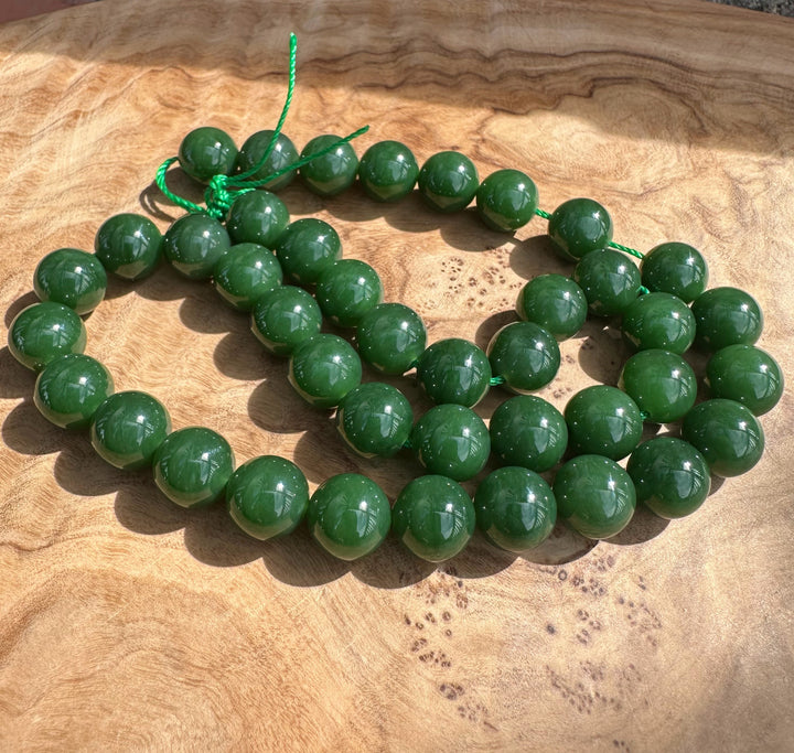 Rich dark green siberian beads on wooden base
