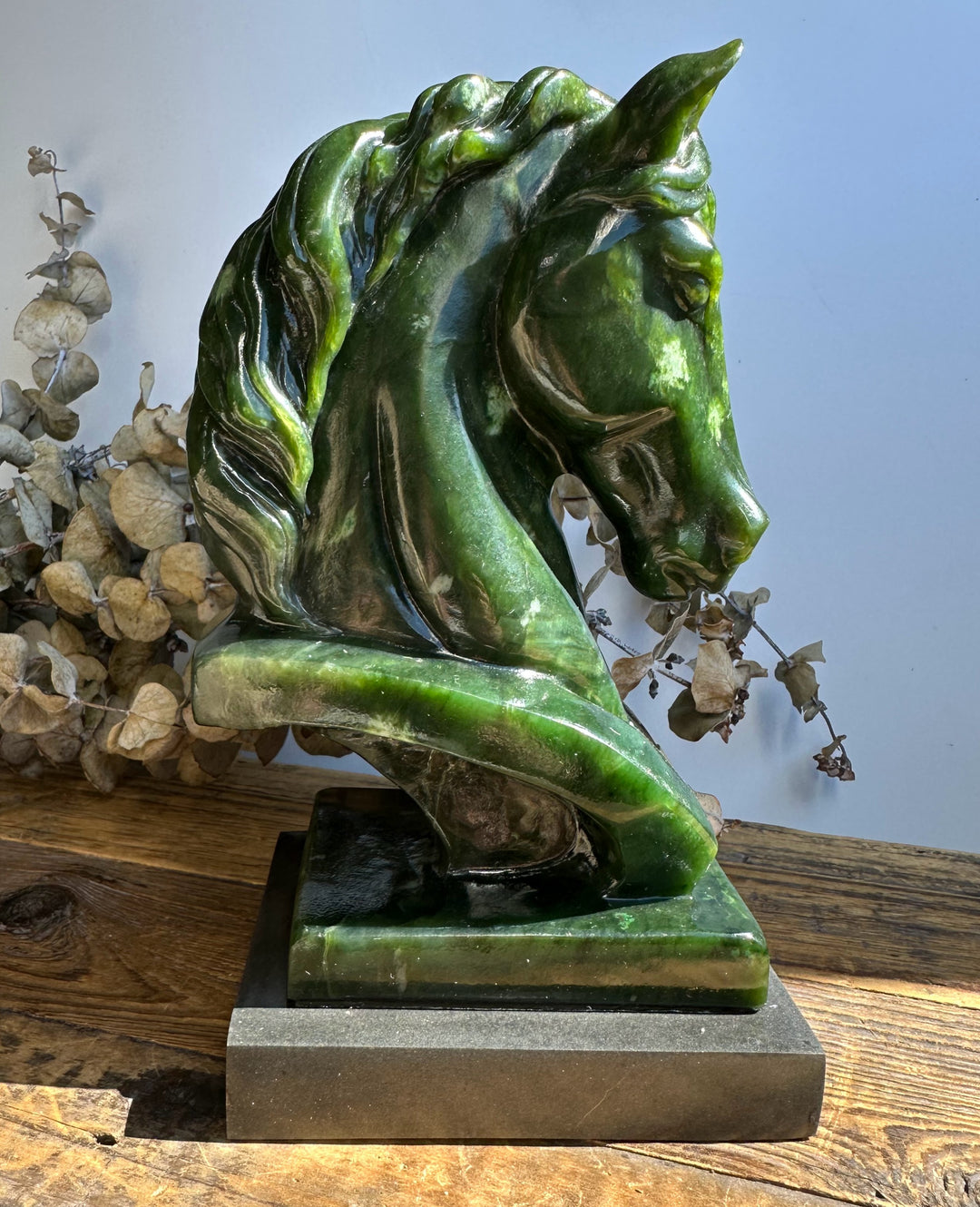Canadian nephrite jade horse bust in side profile with a glossy green finish.
