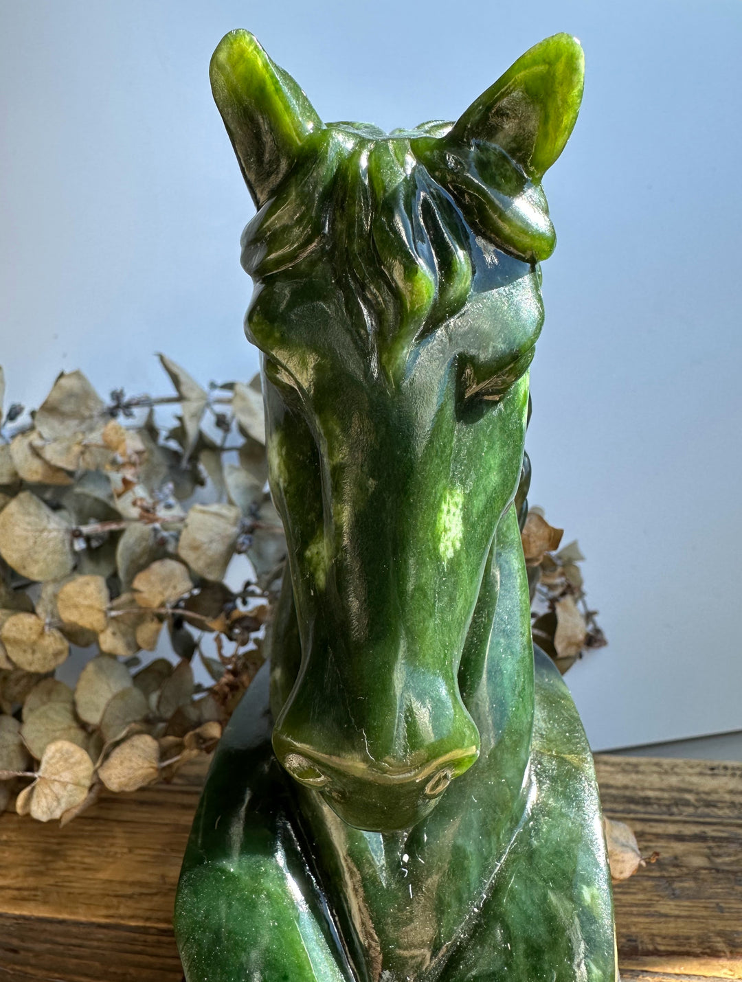 Canadian nephrite jade horse head sculpture in green front view with a flowing mane.
