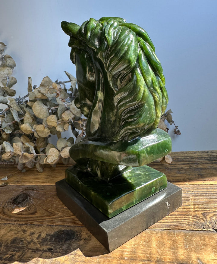 Canadian nephrite jade horse sculpture 6 inches viewed from the rear on a dark base.