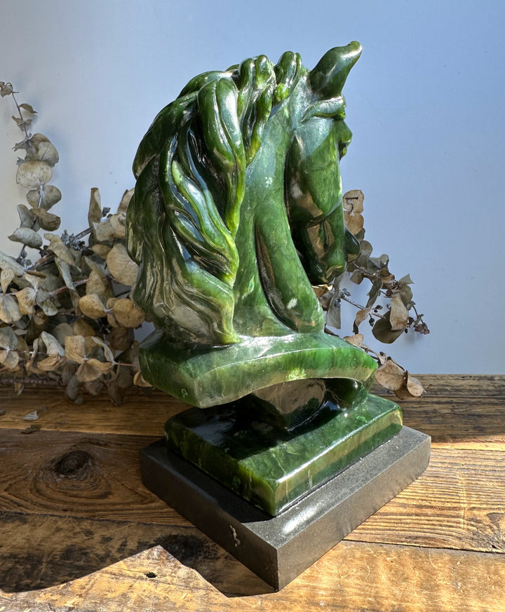Green nephrite jade horse bust viewed from a different angle with a detailed mane on a two tier pedestal.
