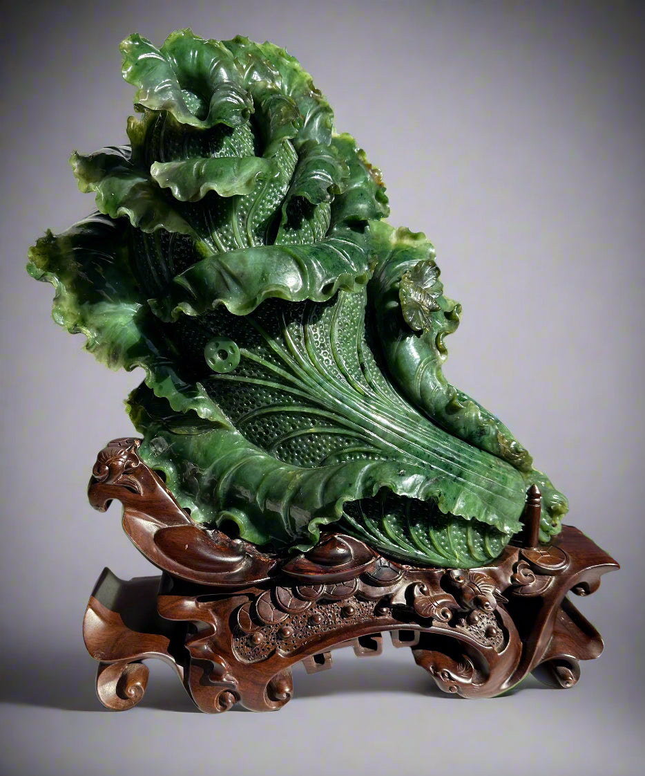 Large Canadian jade Chinese cabbage sculpture on an ornate carved wooden stand.
