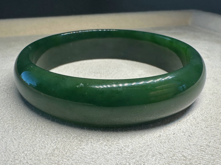 Canadian nephrite jade bangle in dark green with a smooth polished finish