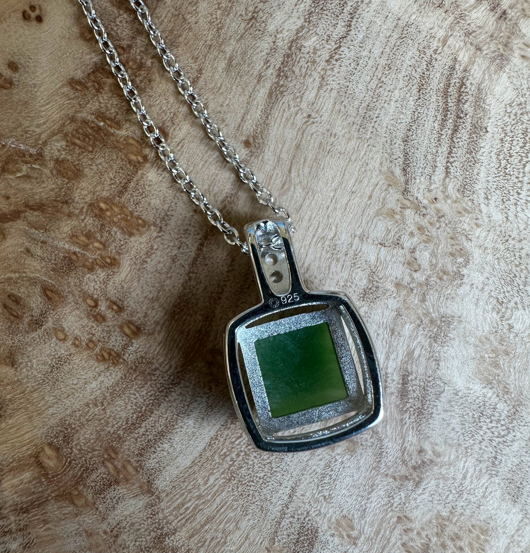 Canadian Jade Pendant with CZ 5560 featuring a square green jade centerpiece in a silver frame on a chain