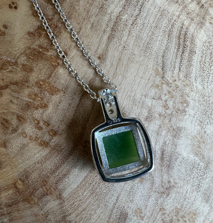 Canadian Jade Pendant with CZ 5560 featuring a square green jade centerpiece in a silver frame on a chain