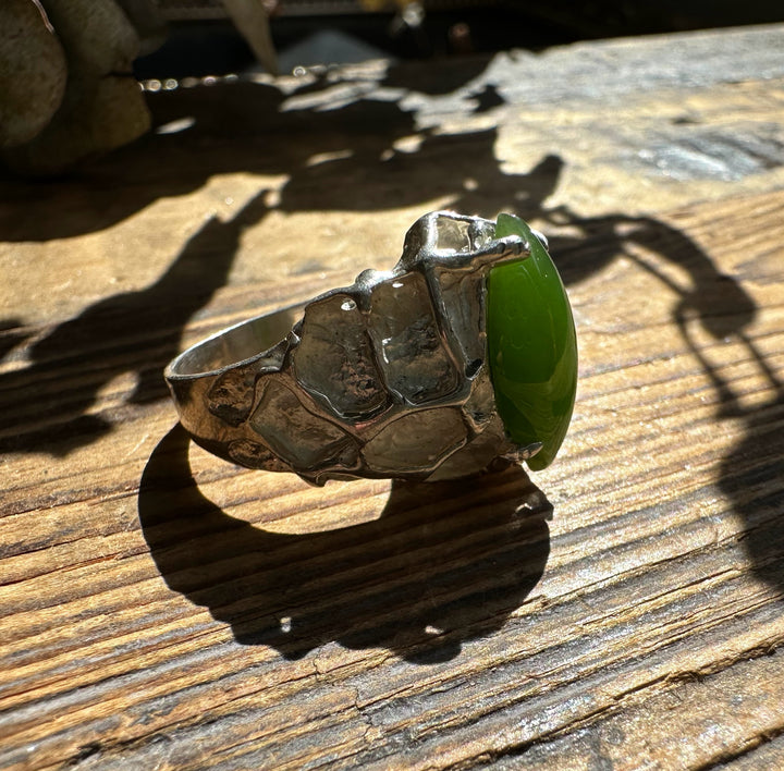 Side view of a hammered silver ring featuring a green jade cabochon