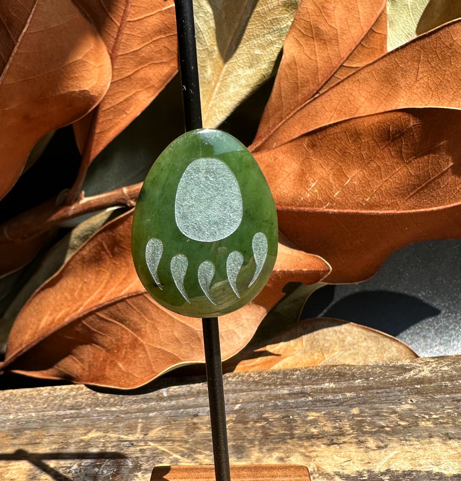 Canadian Jade Bear Paw Magnet green oval with a silver paw print design