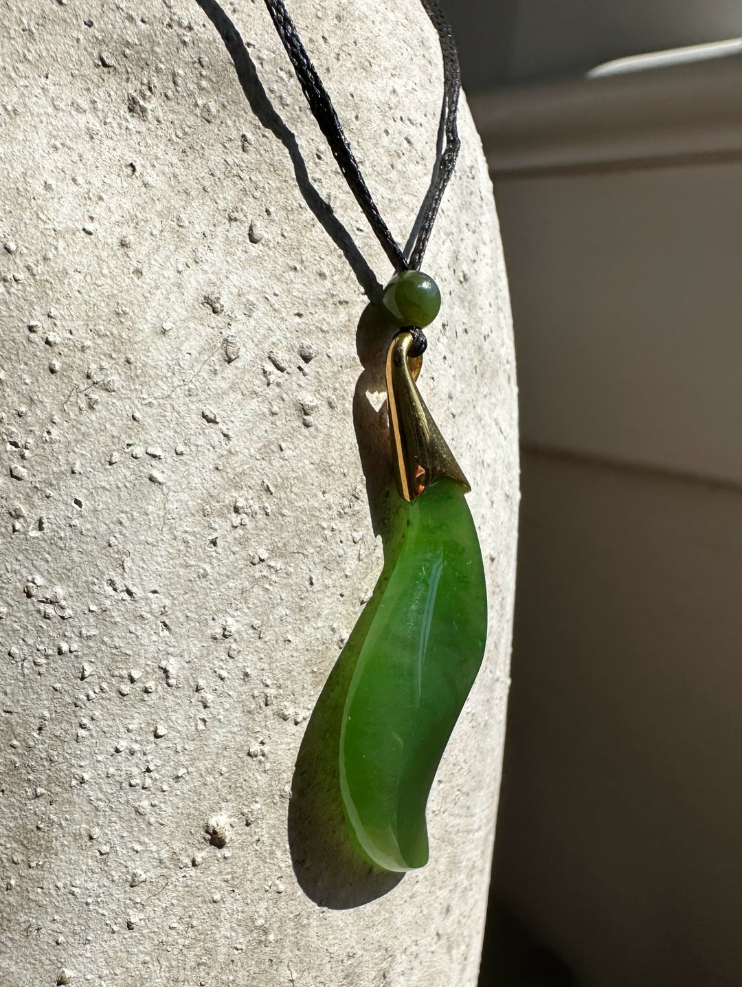 Canadian nephrite jade pendant on a black cord with a small bead