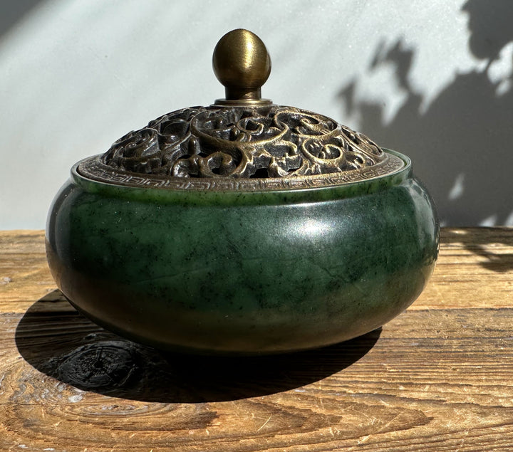 Nephrite jade incense burner with a rounded bronze lid featuring an intricate openwork pattern and a brass knob