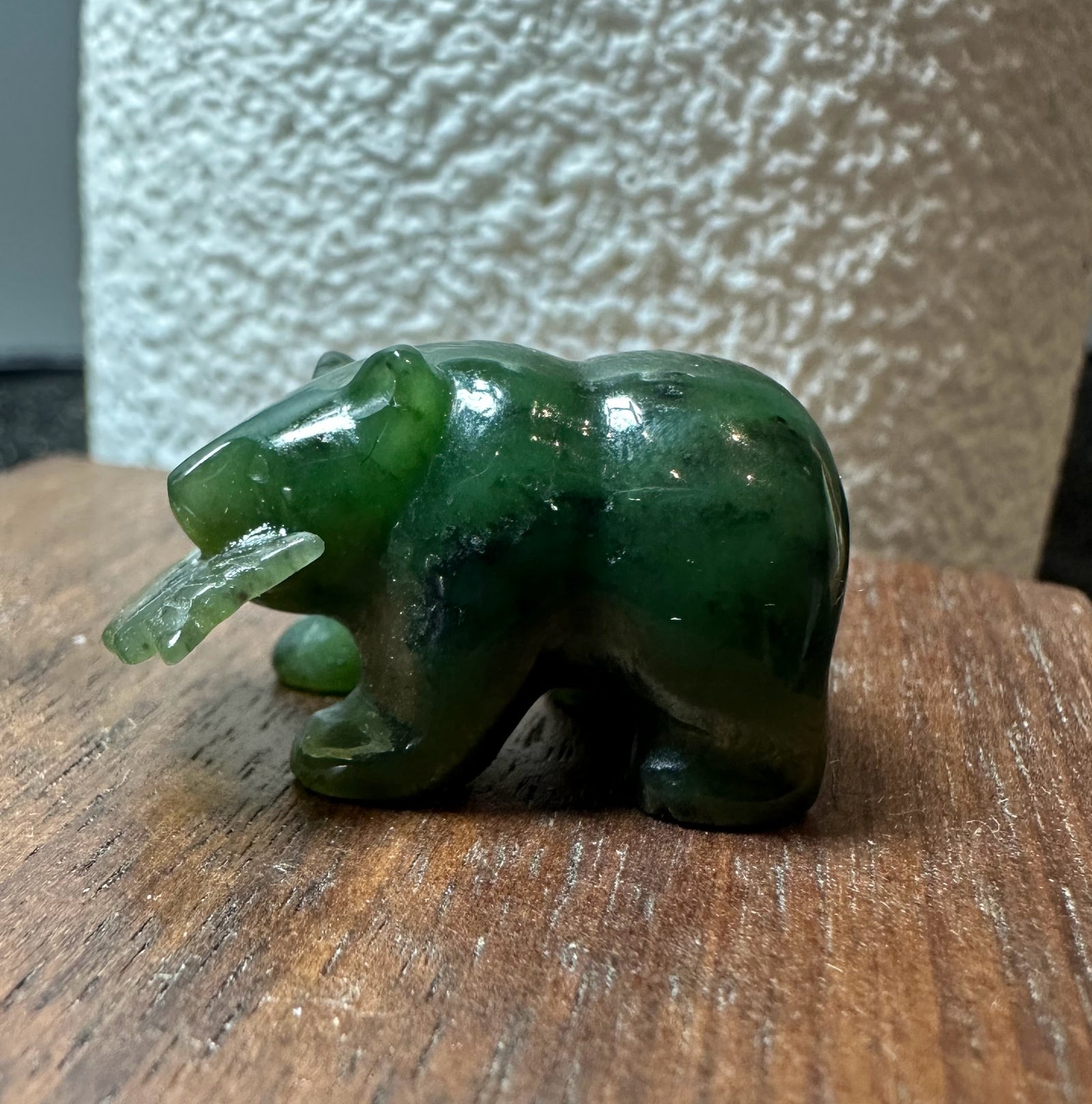 Emerald green jade bear with a jade fish in its mouth