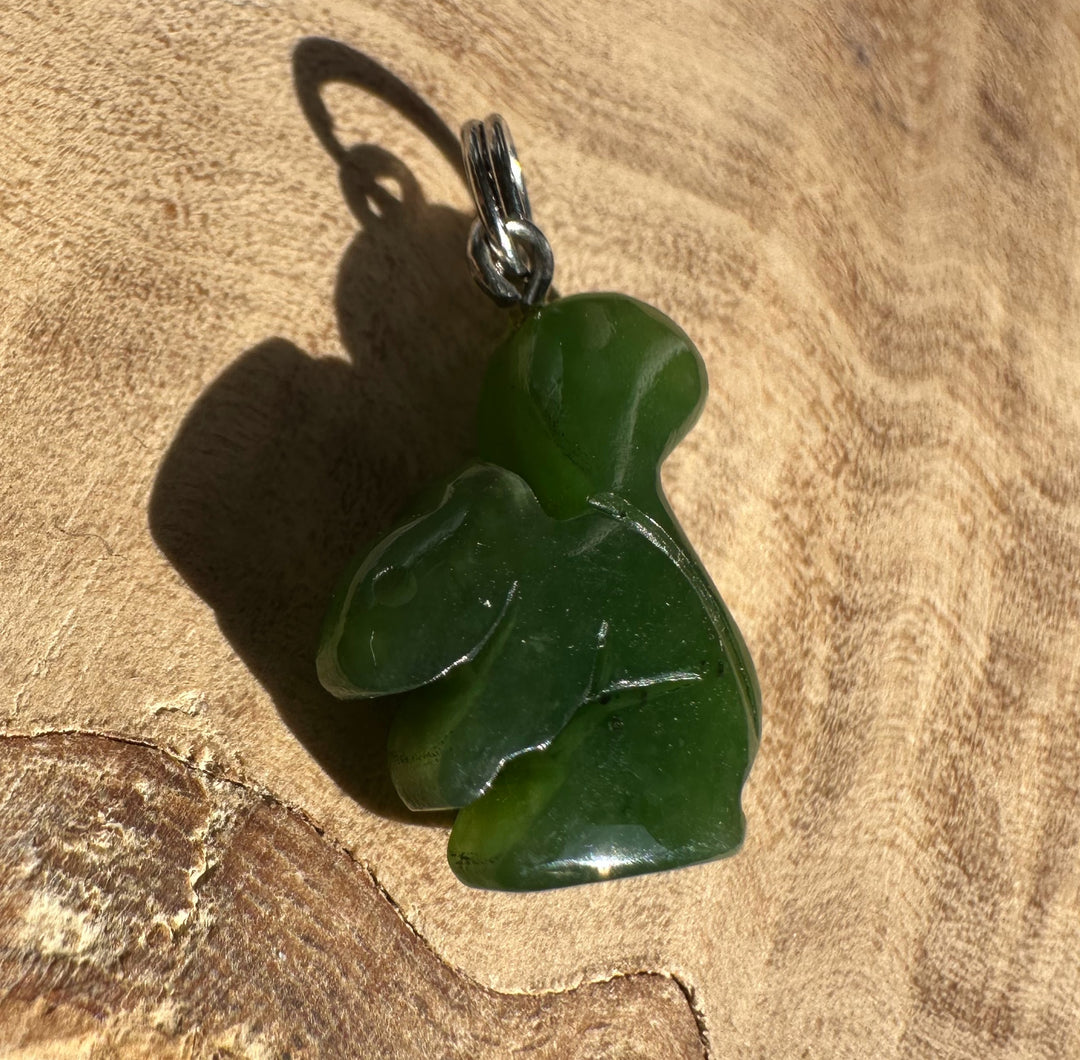 Back view of green jade squirrel charm with metal loop